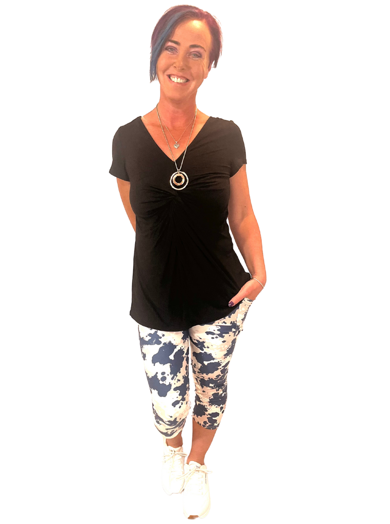WOMAN WEARING NAVY CAMO CAPRIS