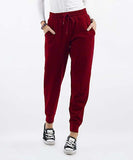 Woman wearing burgundy jogging pants