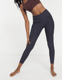 Woman wearing yoga band solid charcoal leggings