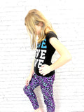 Girl wearing toddler purple galaxy leggings