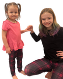 Girls wearing matching purple plaid leggings