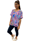 WOMAN WEARING BRIGHT BLUE SUMMER SHIRT