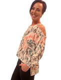 WOMAN WEARING AN OPEN SHOULDER TIE-DYE SWEATER