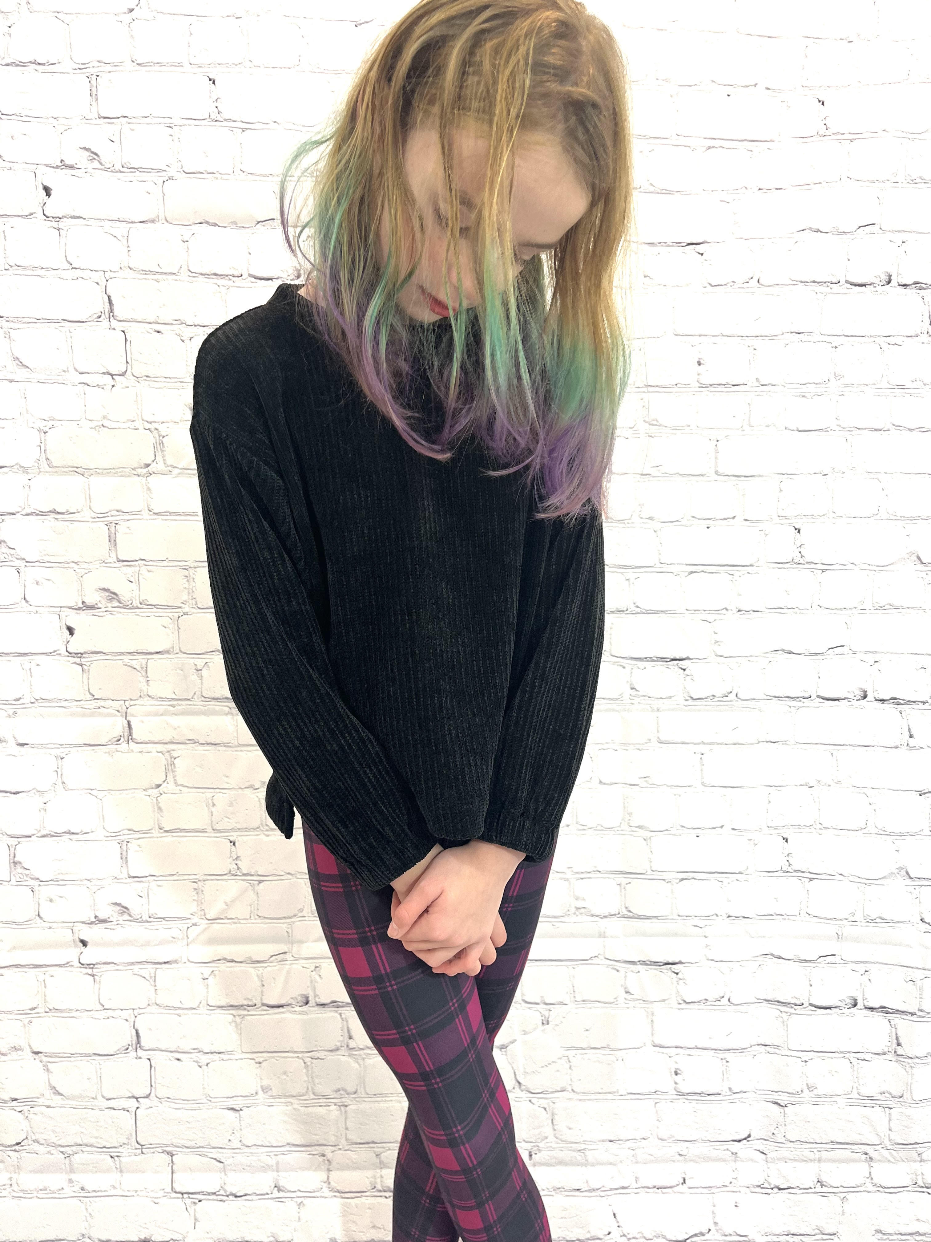 Toddler wearing purple plaid leggings
