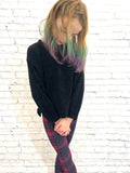 Toddler wearing purple plaid leggings