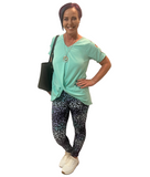 WOMAN WEARING MINT SHIRT AND LEGGINGS