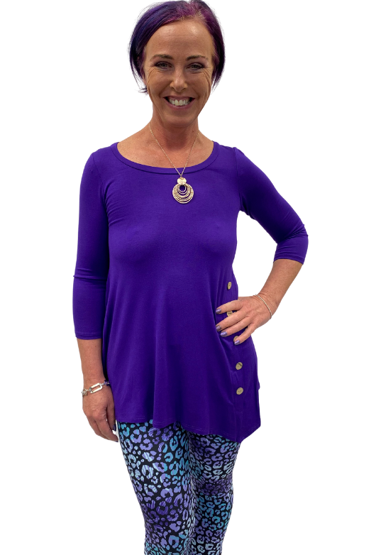 Woman wearing teal and purple yoga band leggings