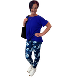 WOMAN WEARING BLUE FLORAL YOGA LEGGINGS