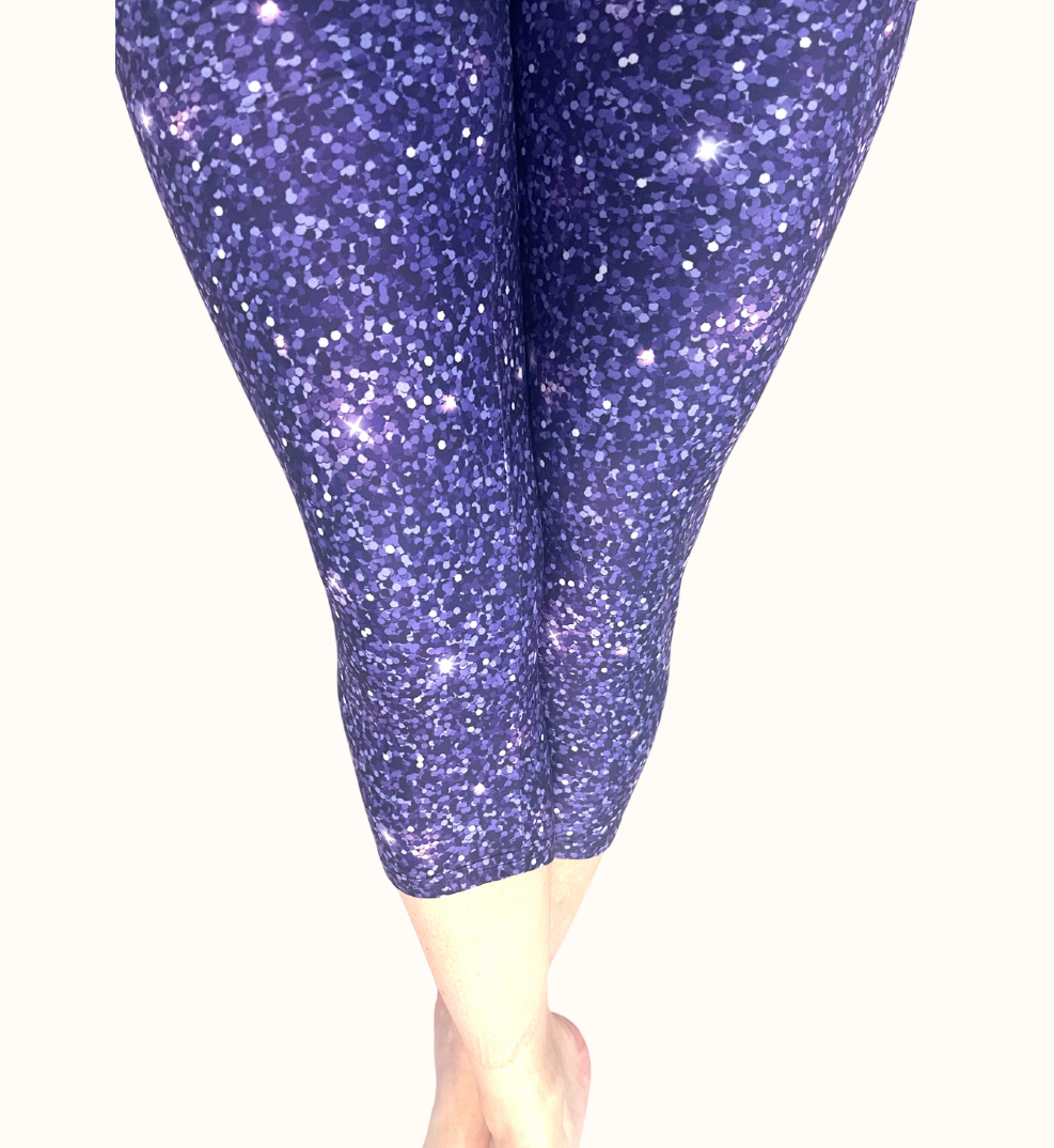 WOMAN WEARING PLUS SIZE PURPLE GALAXY CAPRIS