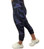 WOMAN WEARING PURPLE AND BLACK LEGGING CAPRIS