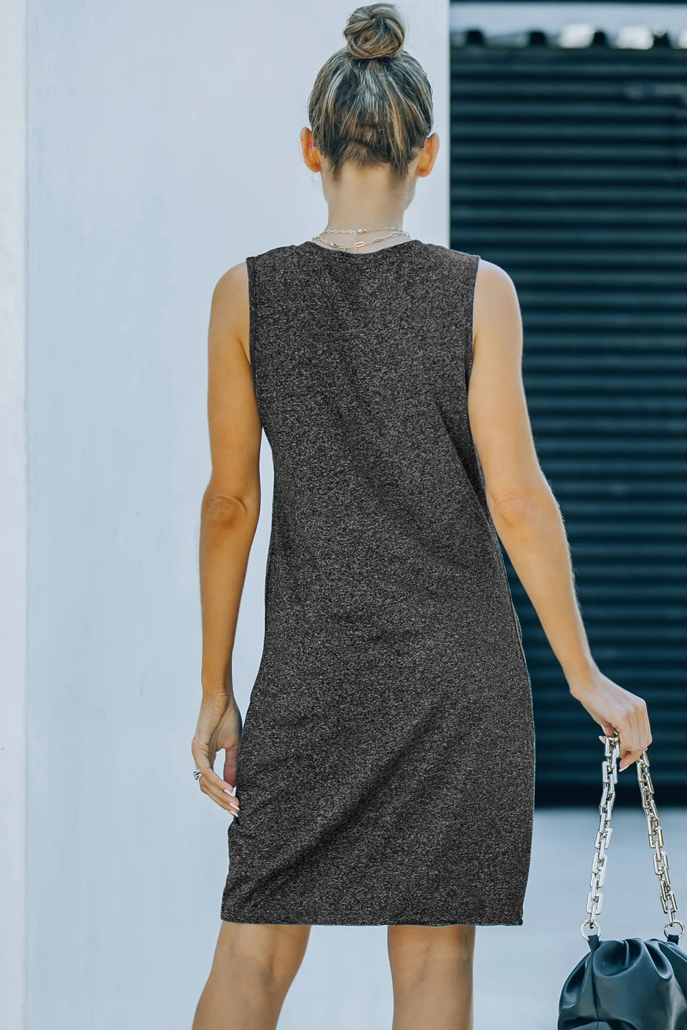 WOMAN WEARING SLEEVELESS BLACK DRESS