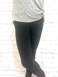Girl wearing tween size black leggings