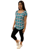 Woman wearing black capris and teal top