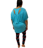 WOMAN WEARING PLUS SIZE OPEN BACK BLUE SHIRT