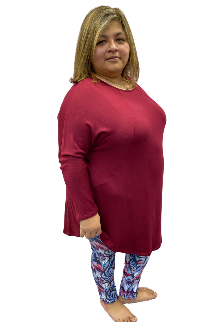 Woman wearing plus size burgundy top and leggings