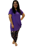 WOMAN WEARING PLUS SIZE PURPLE SHORT SLEEVE SHIRT WITH SIDE KNOT
