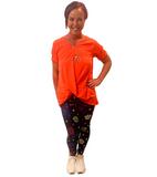 WOMAN WEARING CORAL CUTOUT SHOULDER TOP