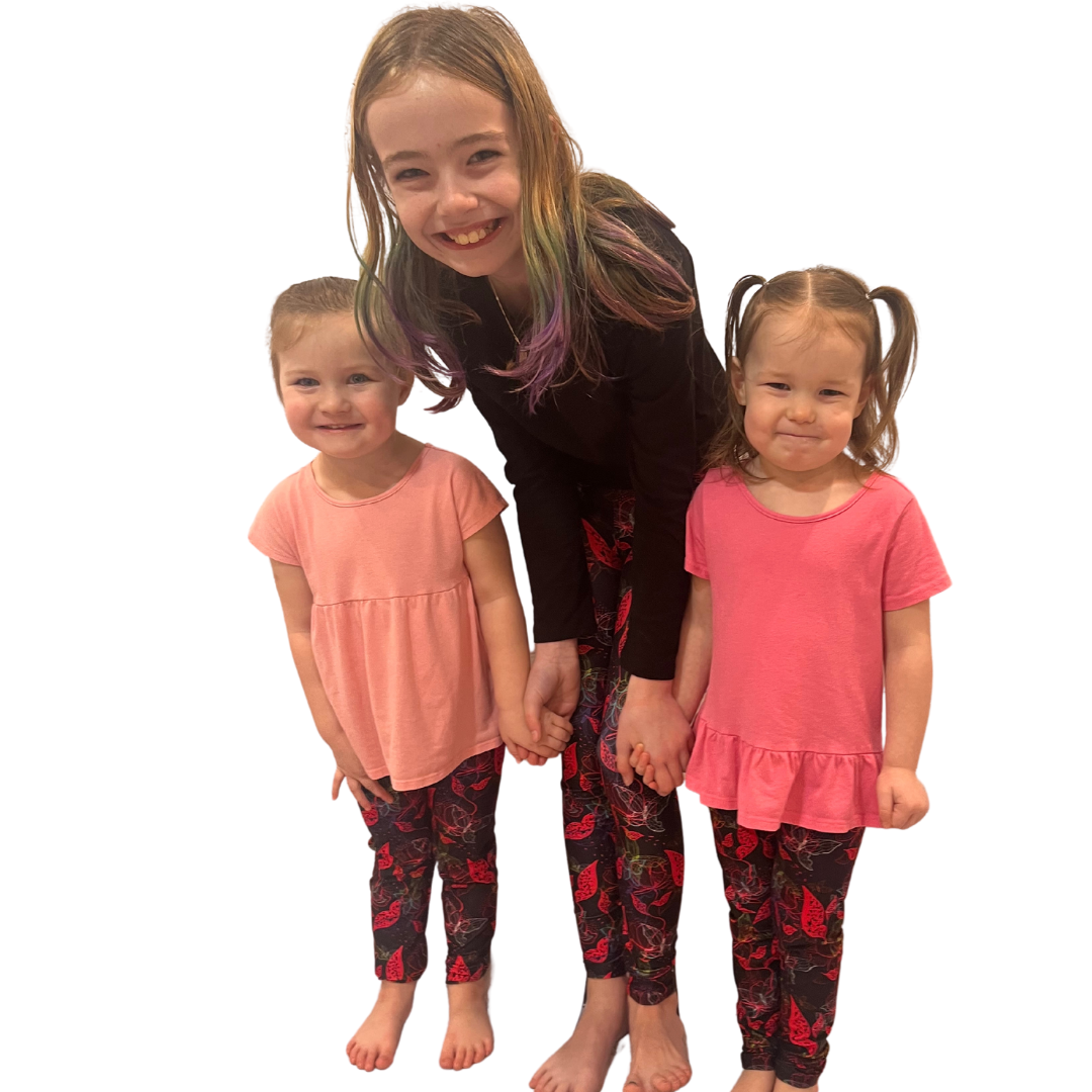 Children wearing pink butterfly leggings