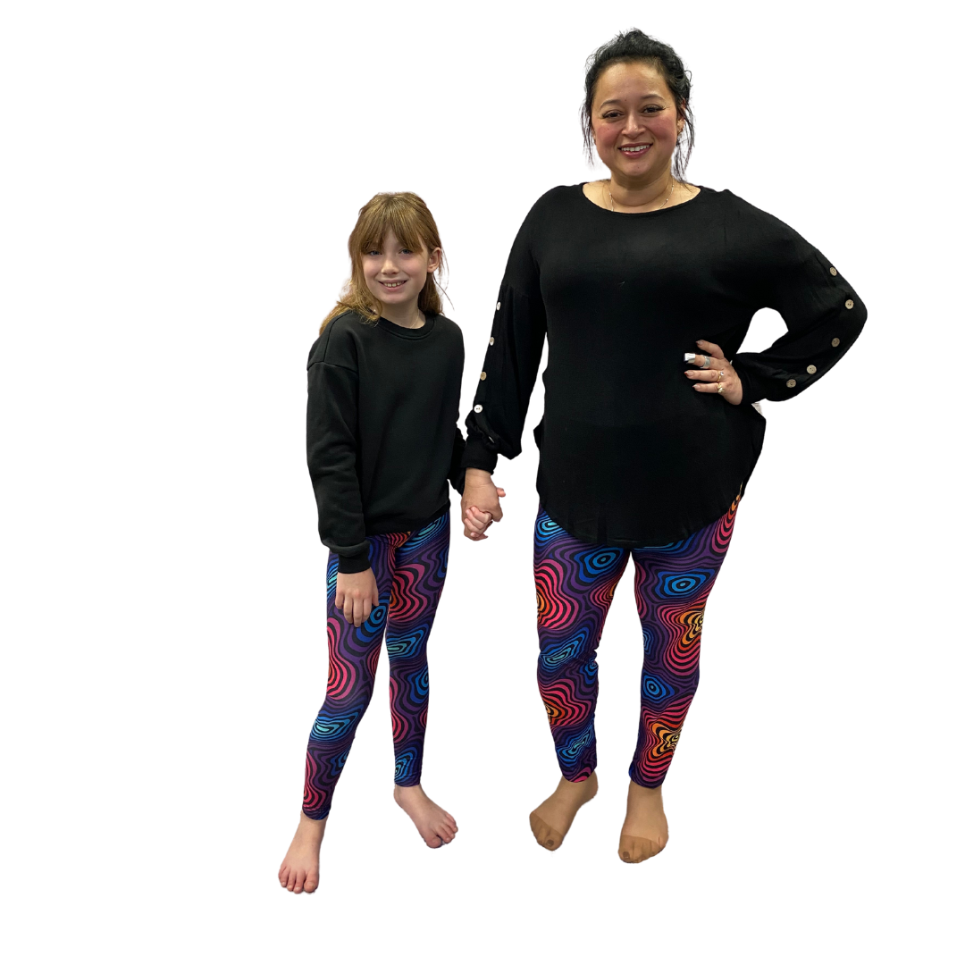 Mom and daughter wearing matching colourful leggings