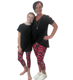 MOM AND DAUGHTER WEARING MATCHING LEGGINGS