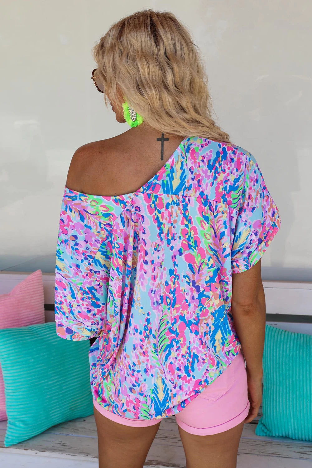 WOMAN WEARING A BRIGHT OFF THE SHOULDER SHIRT