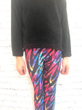 Toddler wearing colourful artistic leggings