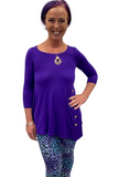 Woman wearing teal and purple yoga band leggings