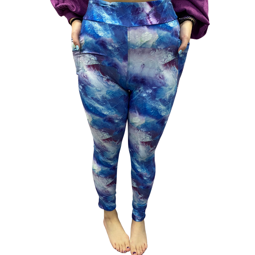 Woman wearing blue galaxy leggings with pockets