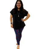 WOMAN WEARING PLUS SIZE BLACK SHIRT AND LEGGINGS