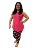 WOMAN WEARING A PINK TOP AND PATTERNED LEGGINGS