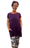 WOMAN WEARING EXTRA PLUS PURPLE UNICORN LEGGINGS