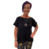WOMAN WEARING BLACK SHIRT WITH FRONT KNOT