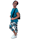 WOMAN WEARING GRAY AND TEAL CAPRIS